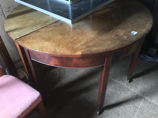 George III mahogany extending two-section circular dining table(-)